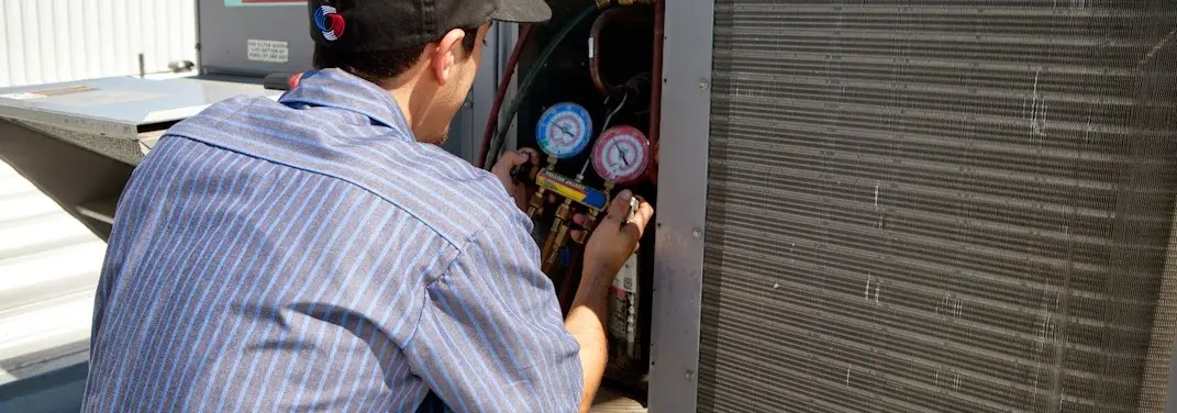HVAC technician servicing a condenser unit in Citrus Park